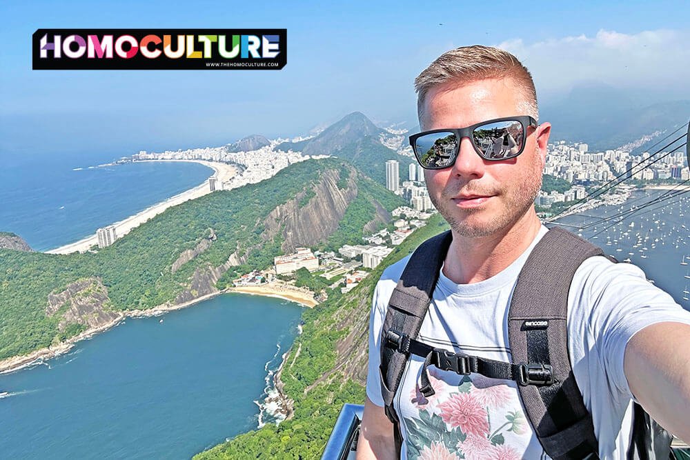 A gay man taking a selfie from the top of Sugarloaf Mountain in Rio de Janiero, Brazil.