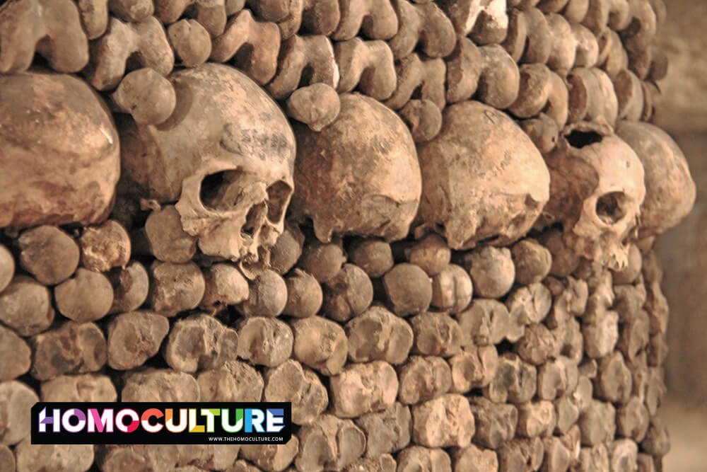 Skulls and bones line the walls of the underground catacombs in Paris, France. 