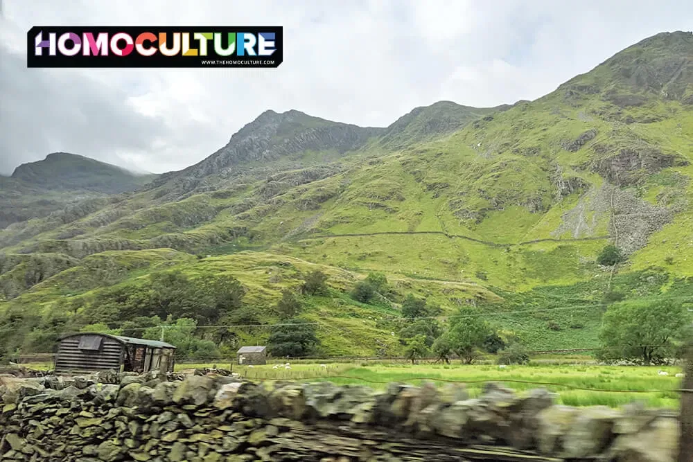 The rolling hillside of northern Wales, lined with piled rock fences.