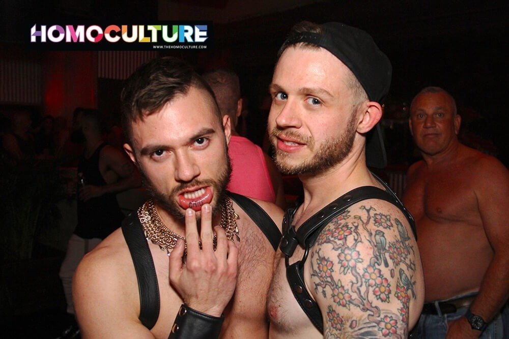 Gay guys wearing leather harnesses at a circuit party.