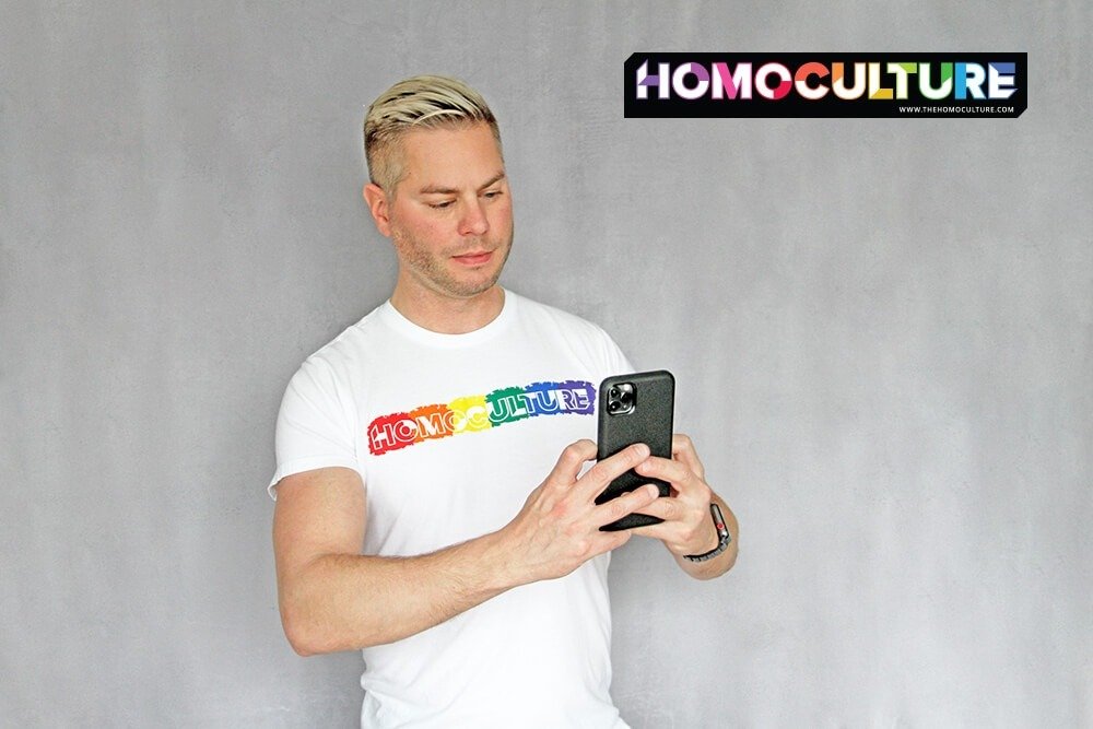 A gay man on a smartphone.