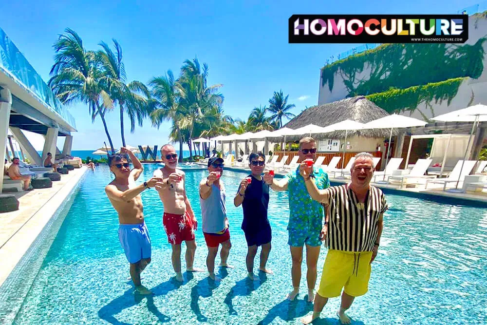 A group of gay men raising glasses in the pool at the W Hotel Punta De Mita. 