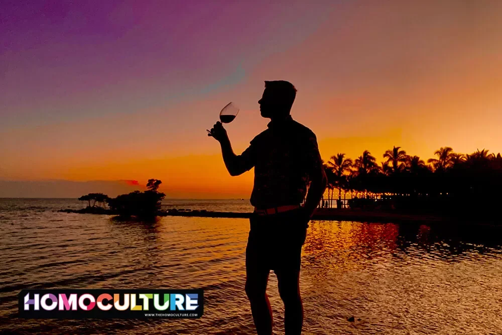 A silhouette of a man drinking a glass of wine at sunset in the Florida Keys.