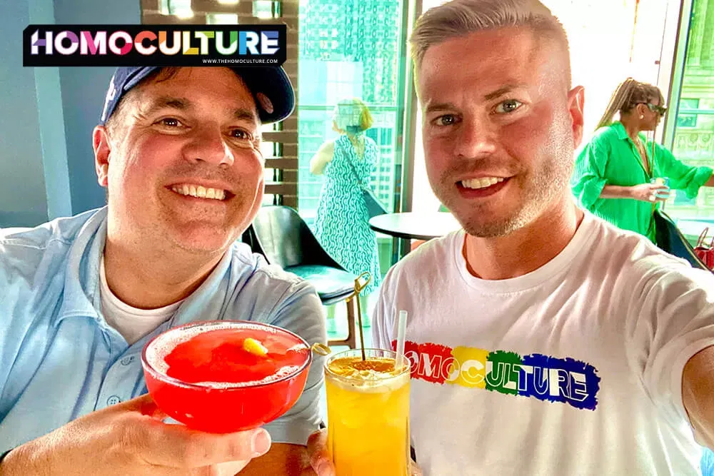 Friends having colorful cocktails at the rooftop bar at the Virgin Hotel Chicago.