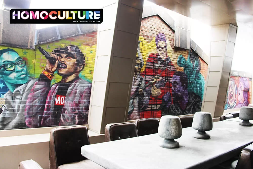 An outdoor communal table with a mural in the background, at the Virgin Hotel Chicago.