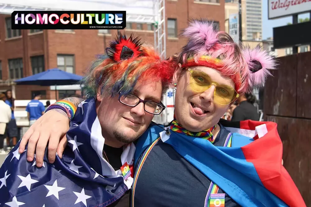 Two friends in colorful outfits at Chicago Pride Fest 2023.