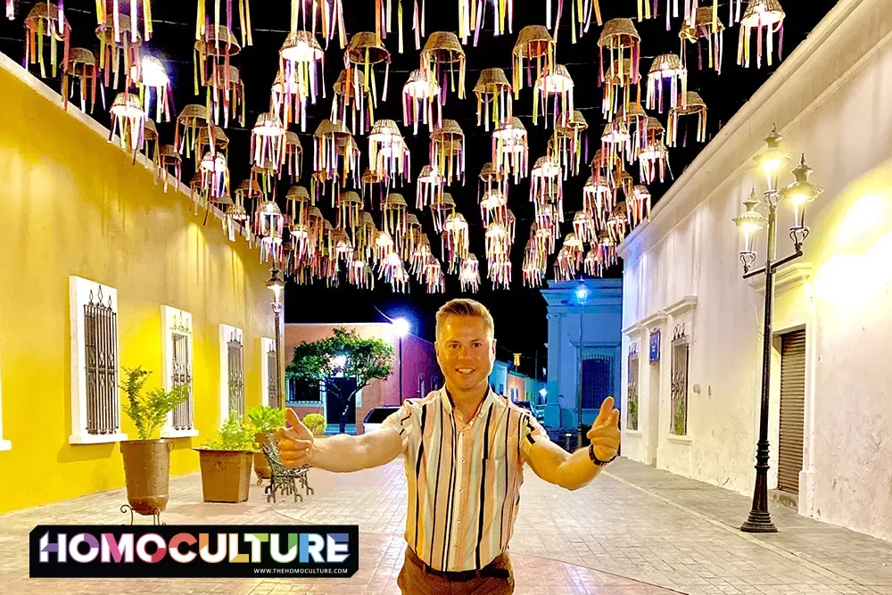 A happy gay man standing in a plaza in Jala, Mexico. 