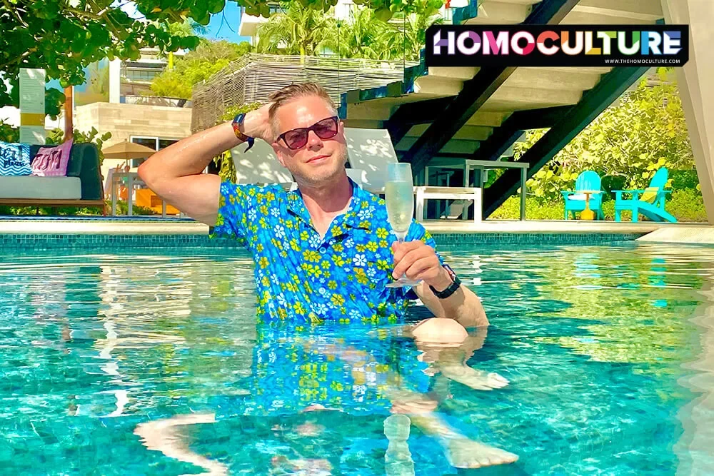 Gay man with a glass of Prosecco in the pool at the W Hotel Punta De Mita. 