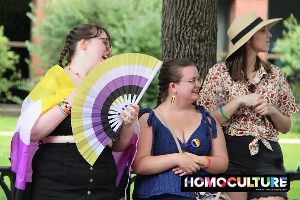 A person holding a gender non-binary fan at the 2023 Fredericton Pride Parade. 