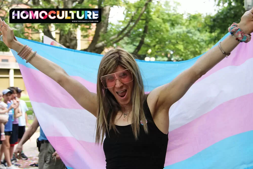 A person proudly carrying a transgender Pride flag in the 2023 Fredericton Pride parade. 