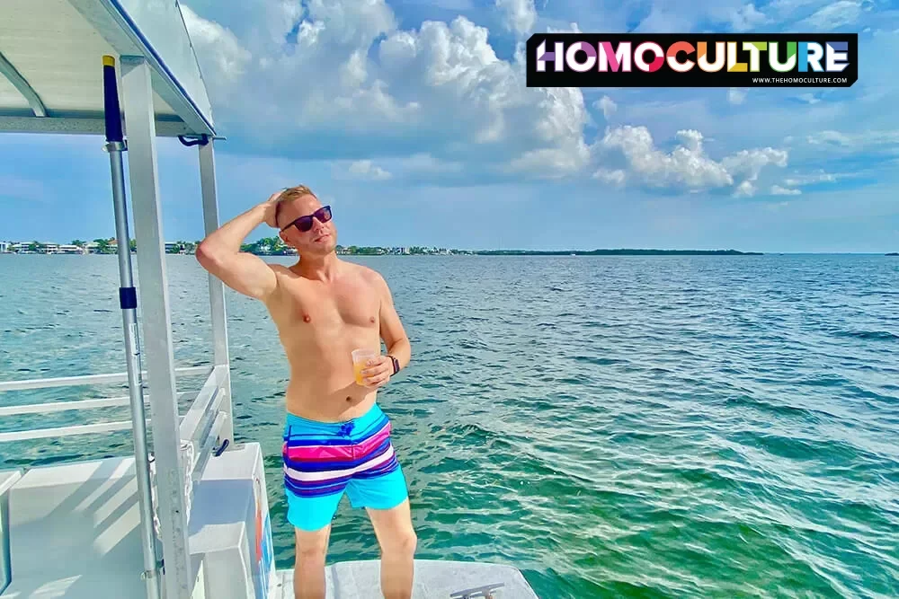 A gay man standing on the back of a snorkling tour boat in the Florida Keys.
