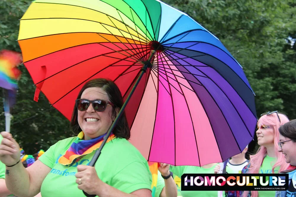 A lady holding a rainbow umbrella in the 2023 Fredericton Pride parade. 