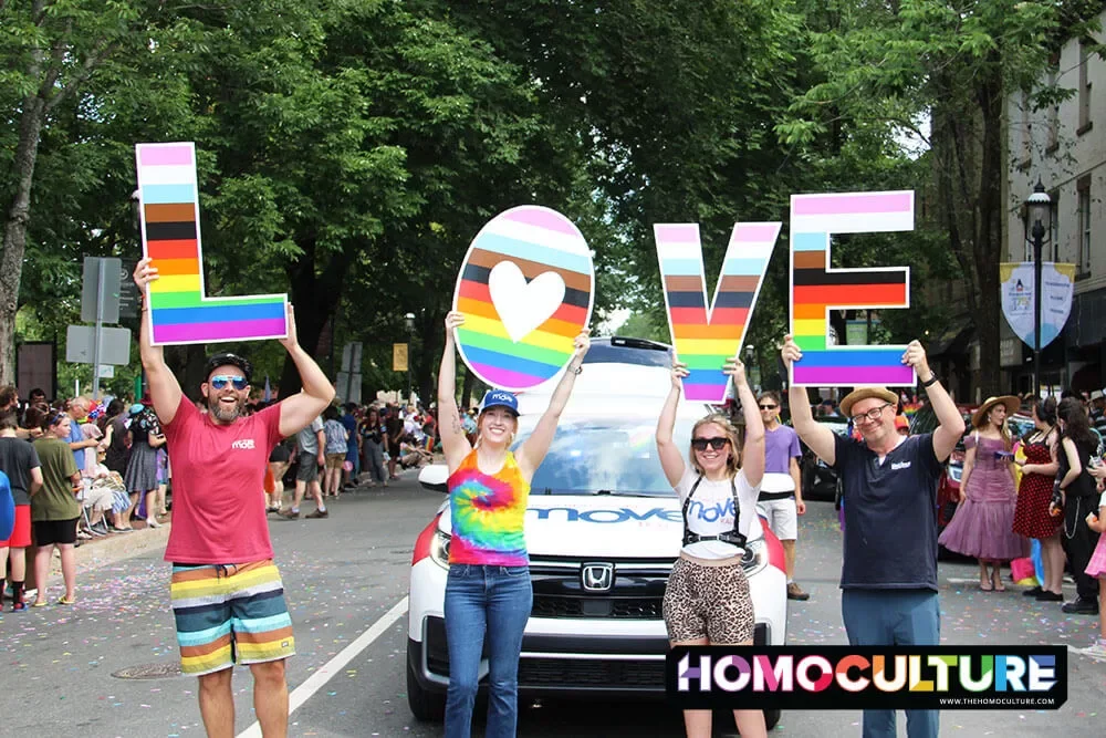 A group of people holding up a sign that spells 'LOVE' in the 2023 Fredericton Pride Parade. 