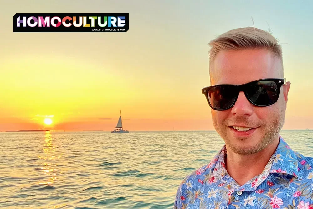 A gay man wearing sunglasses at sunset in Key West, Florida.