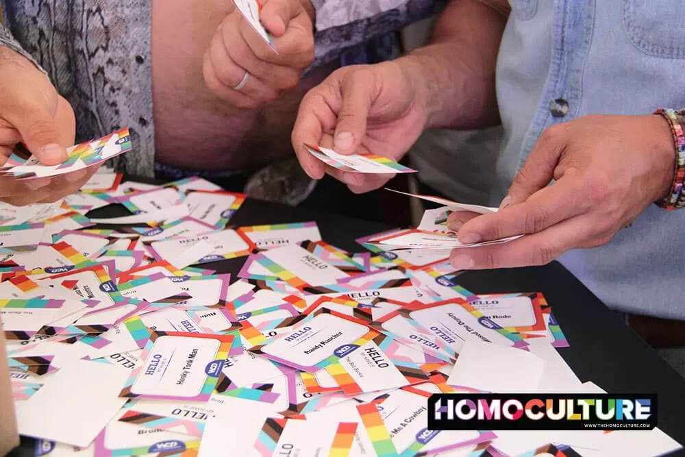People selecting LGBTQ name tags at the 10th annual Pride Day at the 2023 Calgary Stampede. 