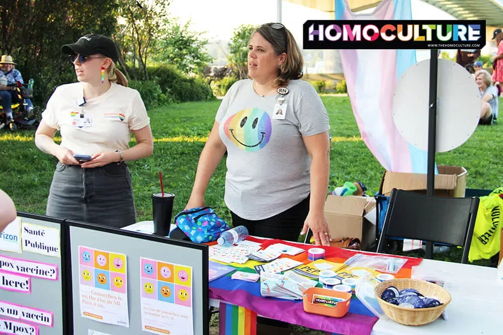 Register nurses volunteer at the Fredericton Pride booth at the Garrison Night Market during Pride Night. 