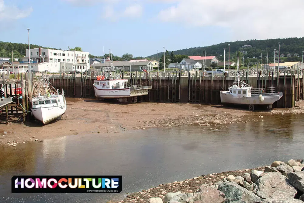 Fishing boats sitting on the ocean floor during low tide in Alma, New Brunswick. 