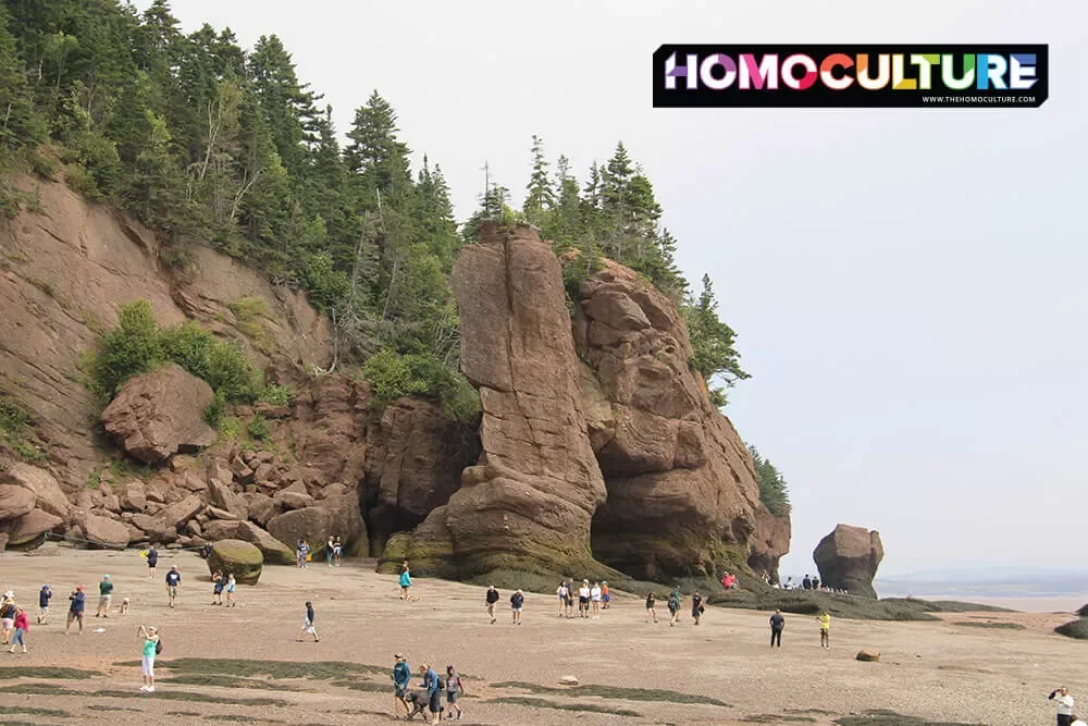 People walking on the ocean floor during low tide at Hopewell Rocks in the Bay of Fundy. 