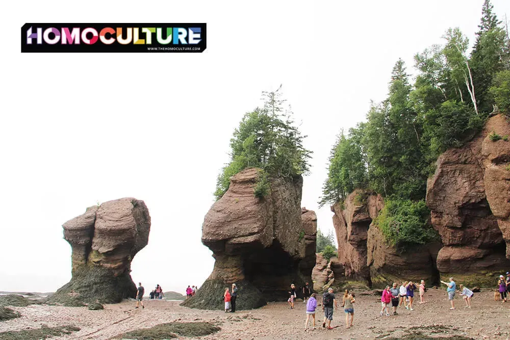 People walking on the ocean floor during low tide at Hopewell Rocks in the Bay of Fundy. 