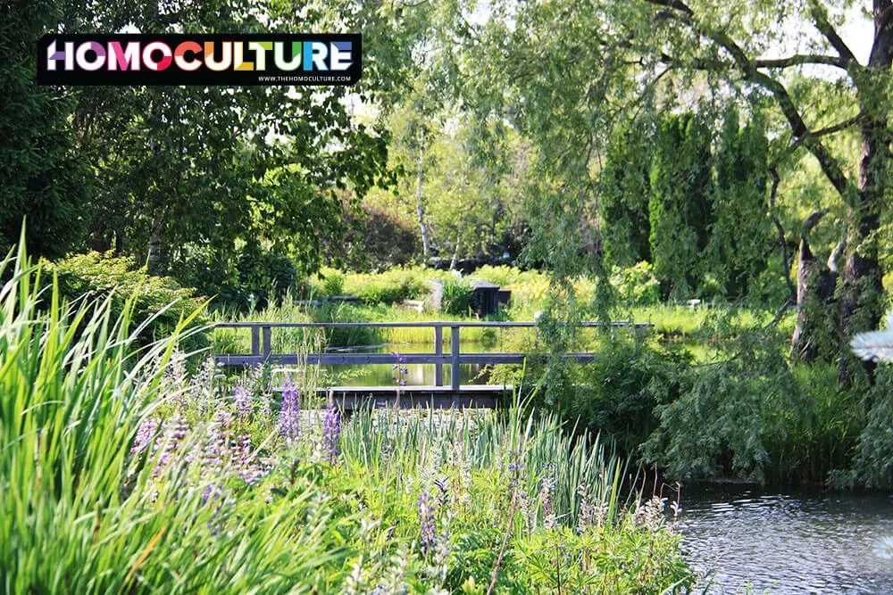 Flowers bloom near a pond and bridge at Kingsbrae Garden. 