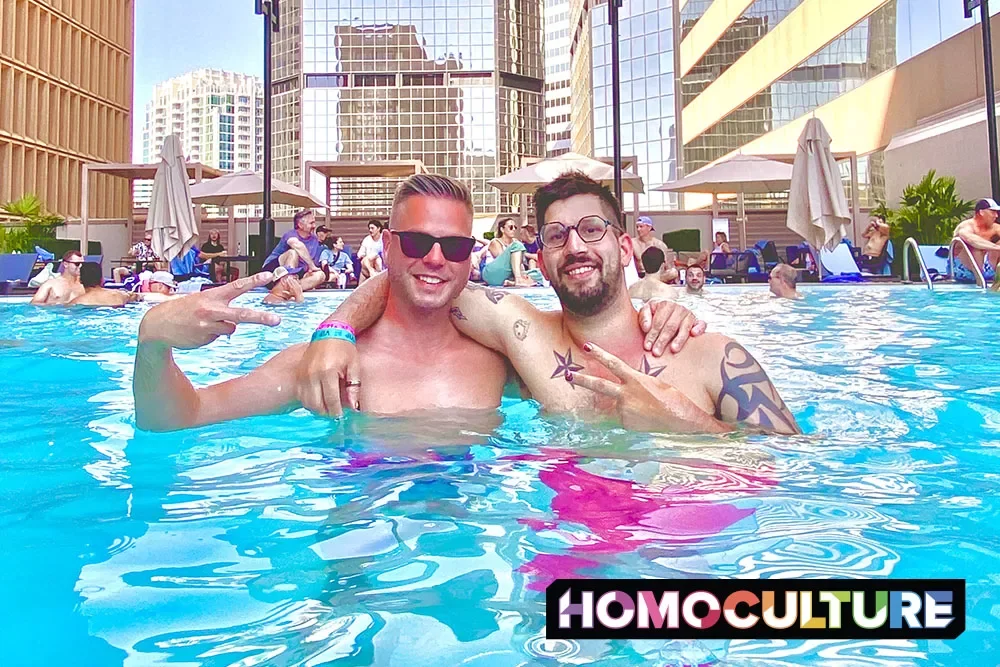 Two gay friends hanging out in the rooftop pool at the Sheraton Denver Downtown Hotel.