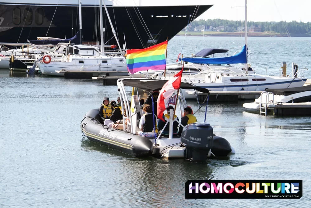A zodiac boat with a Pride flag takes a group of people for a two-hour tour during Pride PEI 2022.