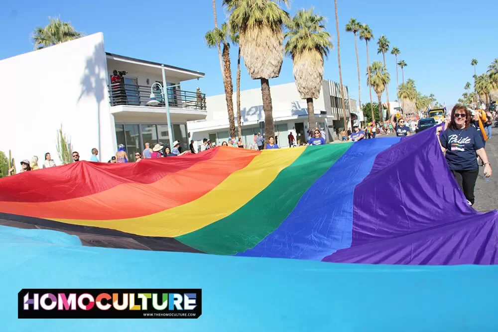 A giant Pride flag being carried down Palm Canyon Drive during the 2022 Palm Springs Pride parade. 