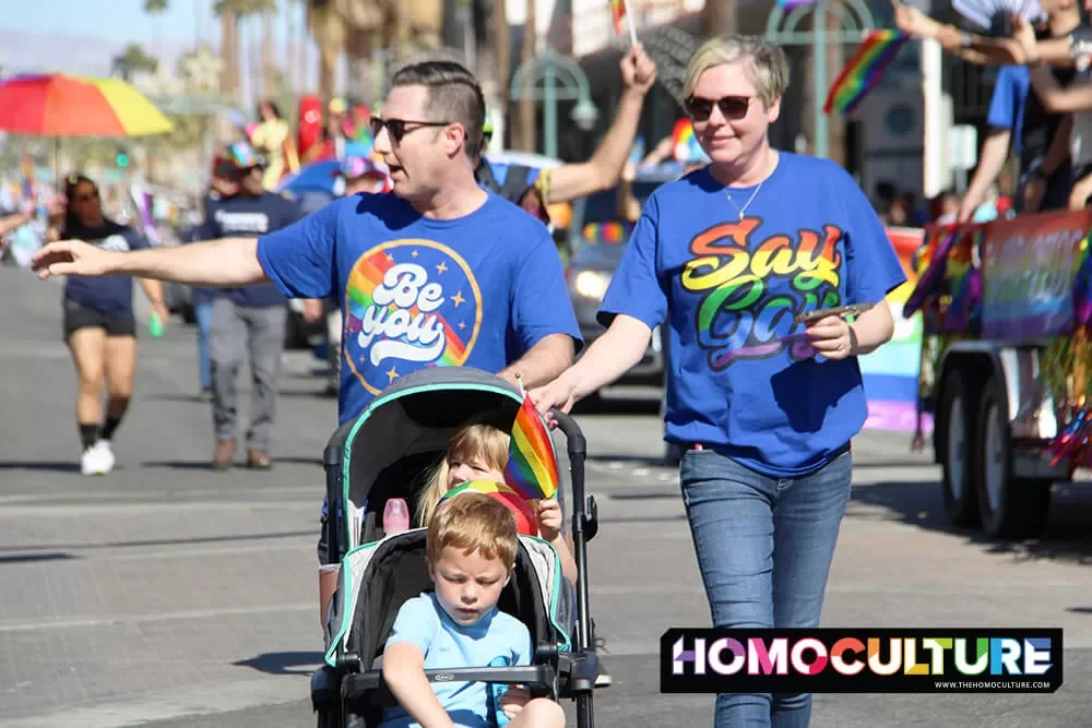 A family marches in the 2022 Palm Springs Pride parade. 