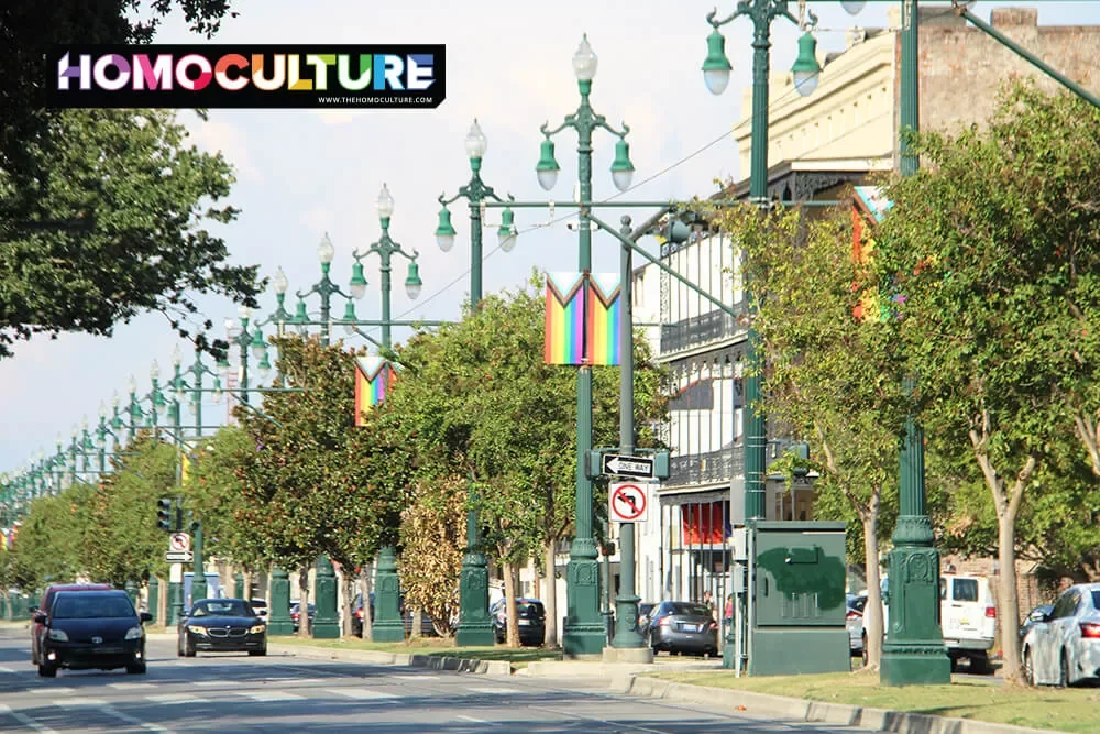 Progressive Pride flag banners line a street in New Orleans. 