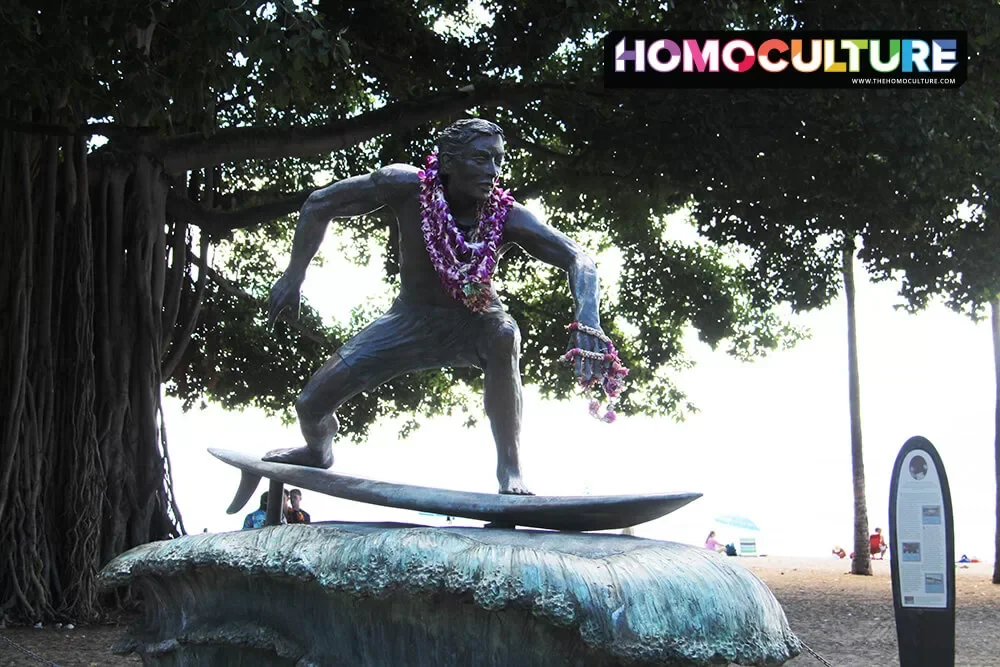 Sculpture of a surfer, adorned with traditional Hawaiian lei's. 