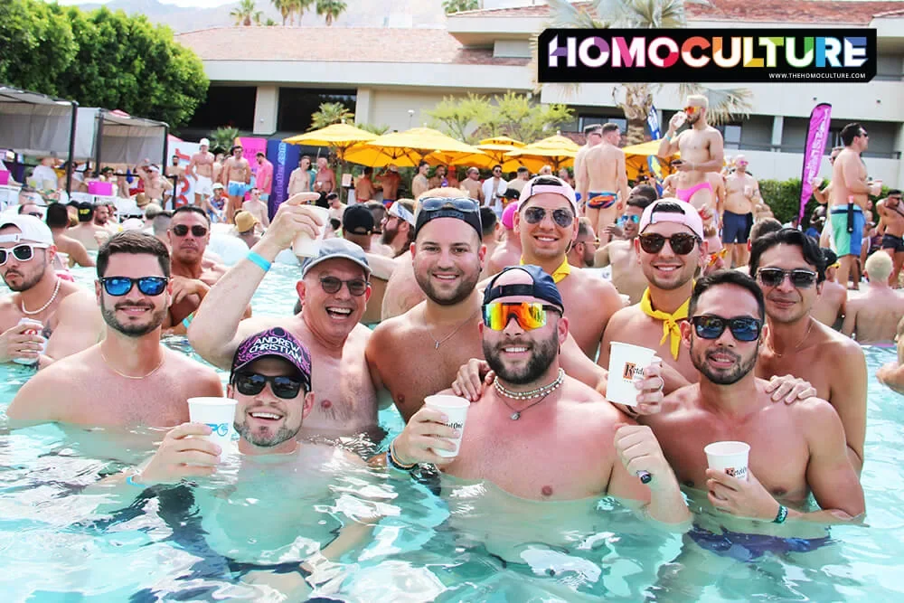 A group of friends in the pool at the Saturday Splash pool party during White Party Palm Springs 2023.