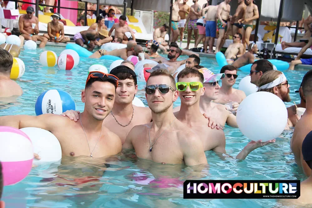 A group of friends in the pool at White Party Palm Springs 2023. 