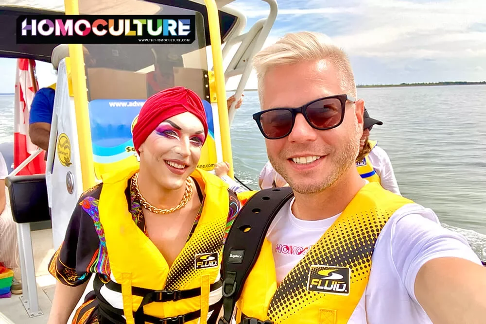 A drag queen poses for a selfie with guests aboard a boat tour during Pride PEI 2022.