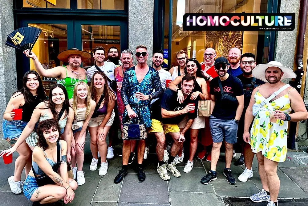 A large group of boys in dresses posing for a photo in the French Quarter during Souther Decadence 2023. 