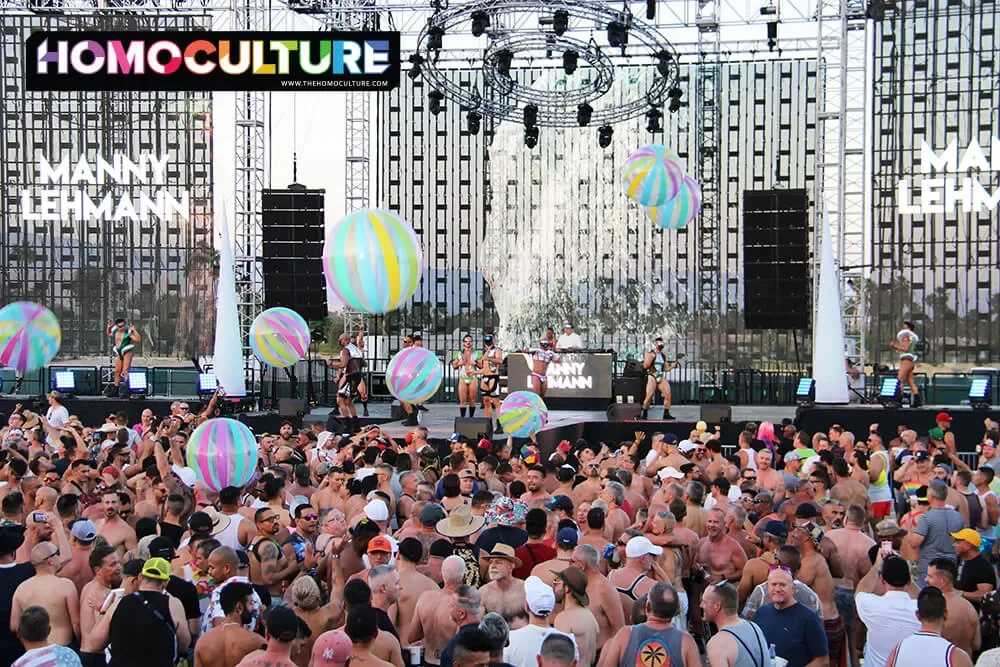 Giant beach balls bounce in the crowd at the Sunday Orbit T-Dance at White Party Palm Springs 2023. 