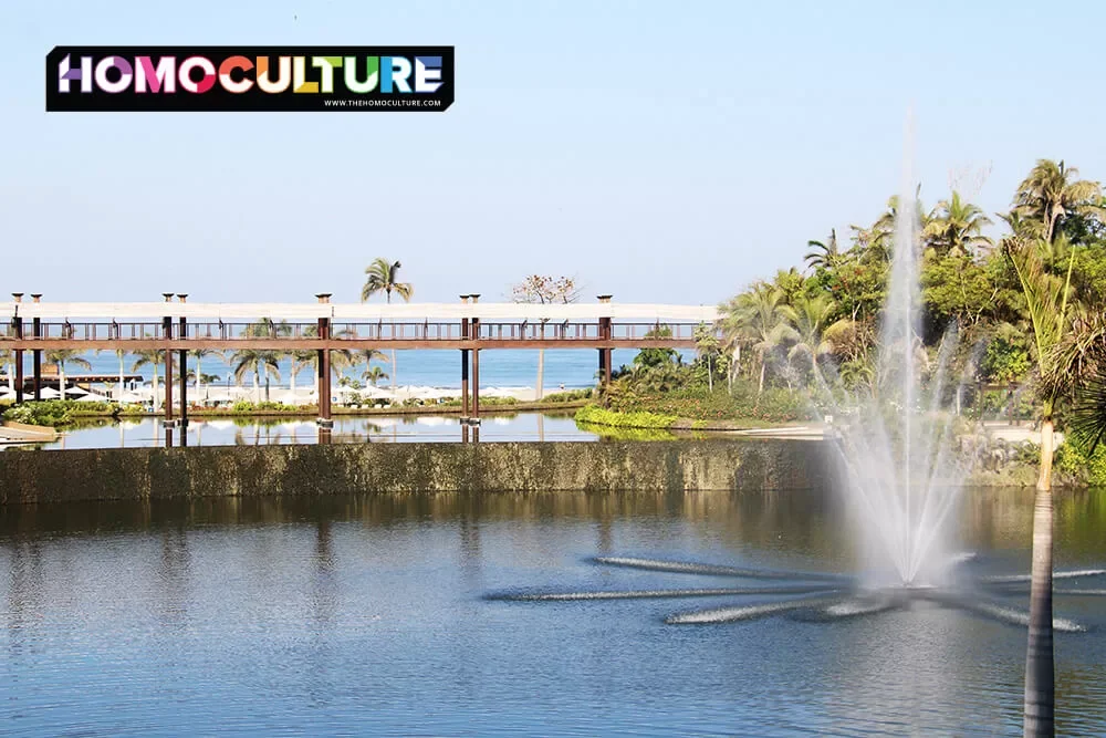 A water fountain sprays high into the air in the middle of a pond at Vidanta Resort. 