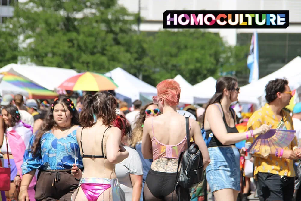 A large crowd of people walking through Denver PrideFest 2023. 