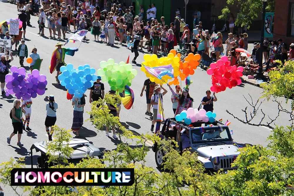 A group of people holding rainbow balloons in the 2023 Denver Pride Parade. 