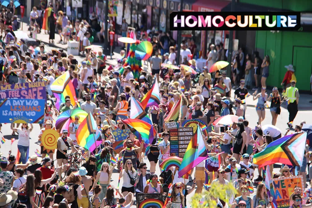 A large group of people carrying Pride flags in the 2023 Denver Pride Parade in Denver, Colorado. 