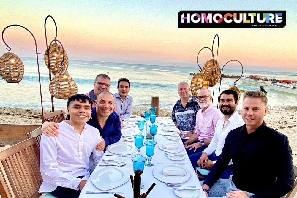 Group of gay men having a sunset dinner by the ocean.