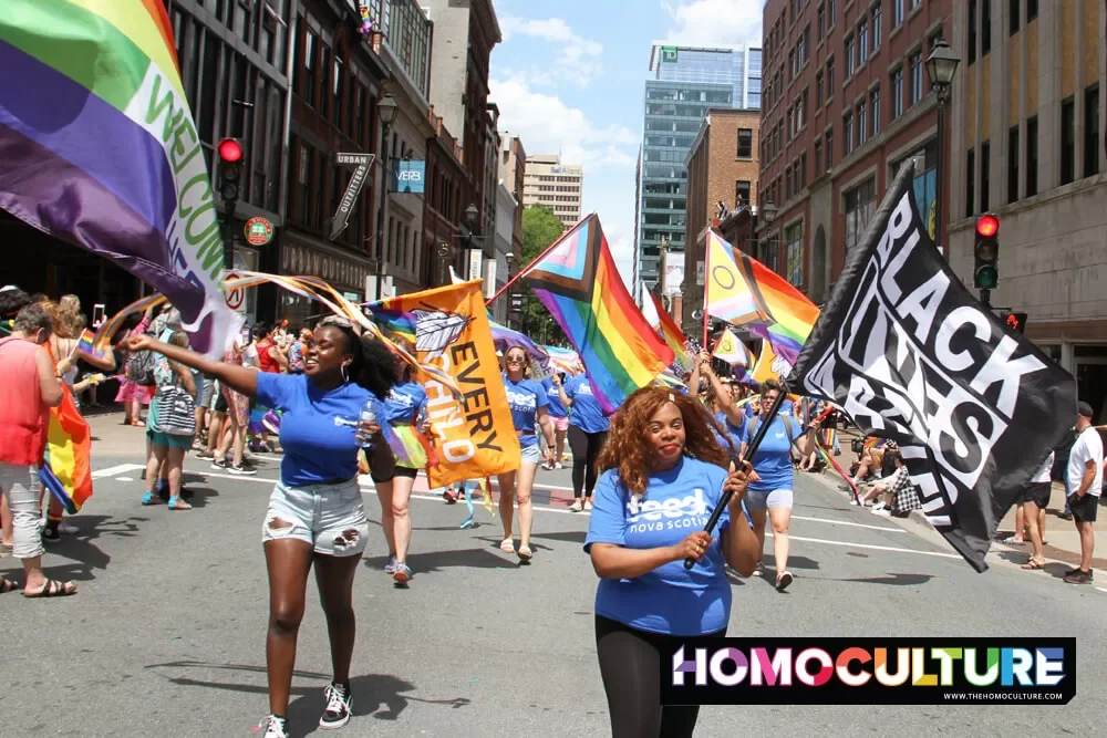 Marchers carrying Pride flags in the 2022 Halifax Pride parade. 