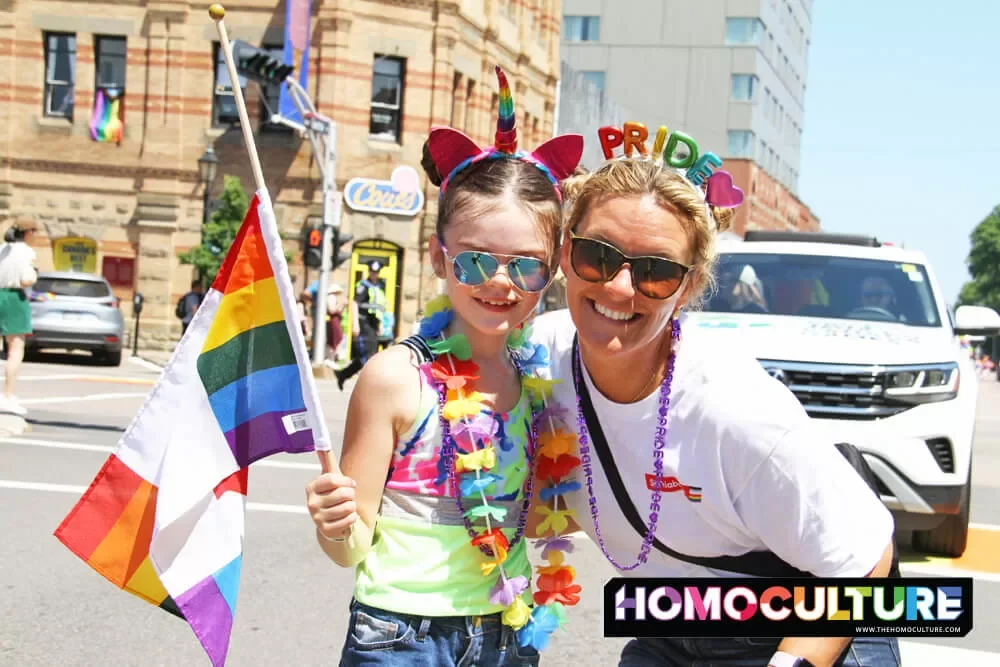 A mother and daughter at a Pride parade.