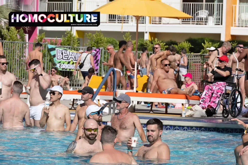Groups of friends enjoying the warm sun at the Aqua Boy Pool Party at White Party Palm Springs 2024. 
