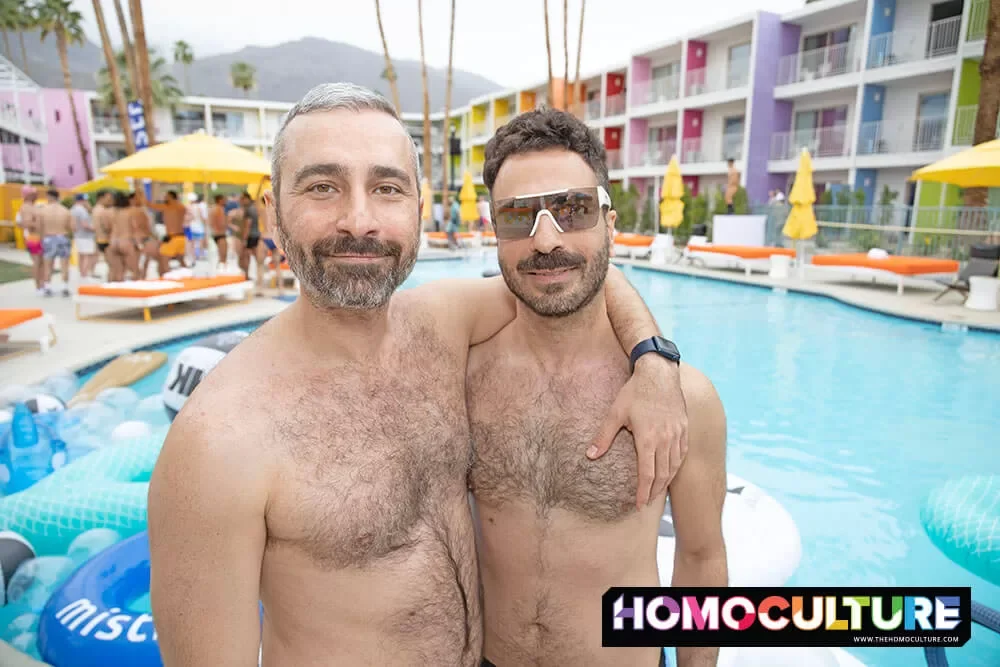 A group of friends having fun, despite the overcast skies, at the White Party Palm Springs 2024 Mermen Pool Party.