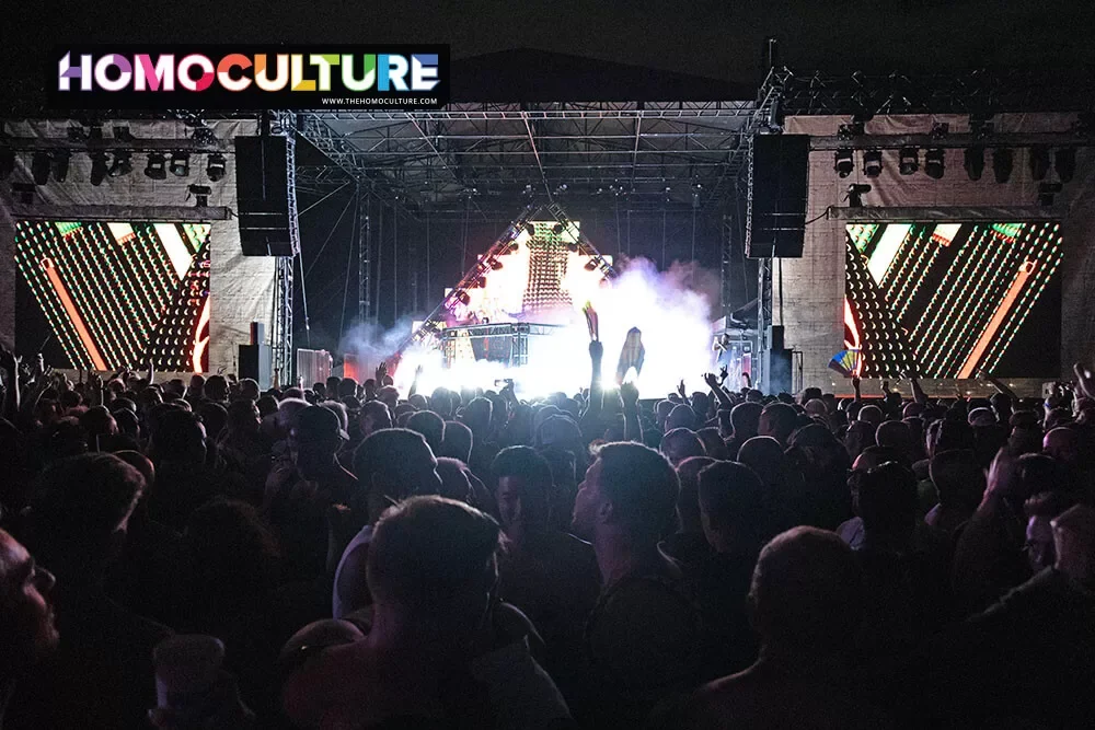 A large crowd dacing in front of the main stage at the Pharoh T-Dance at White Party Palm Springs 2024. 