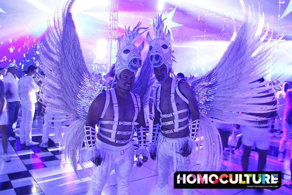 Two guys wearing custom outfits at a circuit party. 