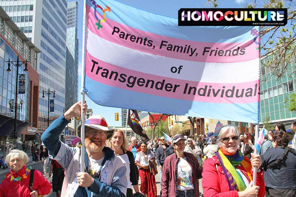 Parents of trans community members march in a Pride parade.
