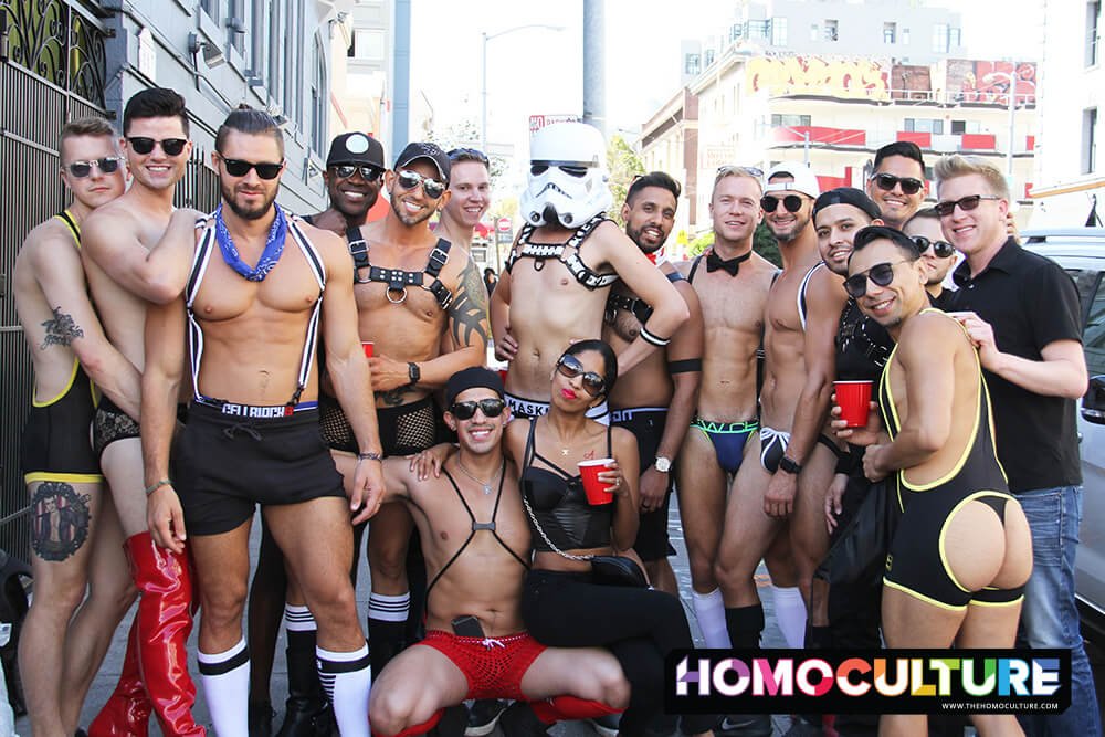 A group of gay friends wearing leather harnesses and fetish gear. 
