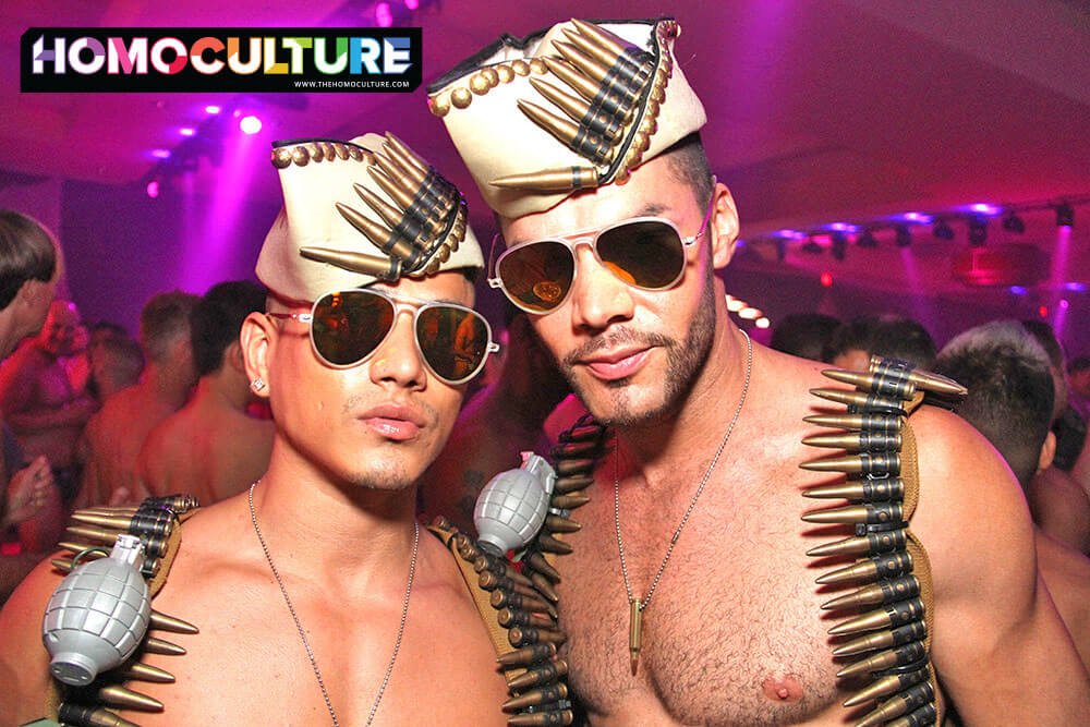 Two guys at a circuit party dressed up in military costumes