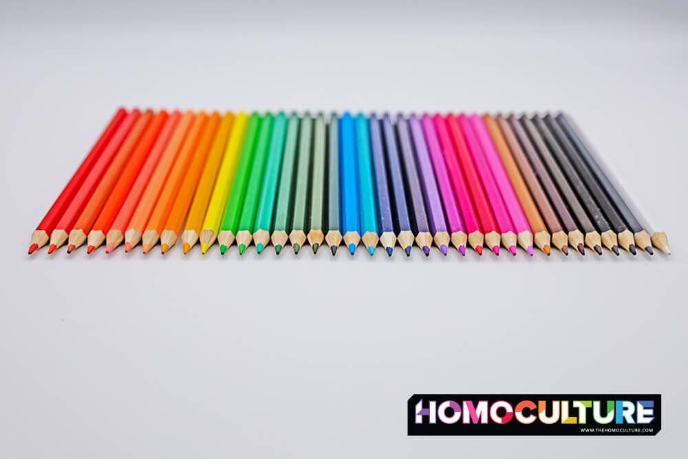 A row of pencil crayons lined up in a colorful rainbow.